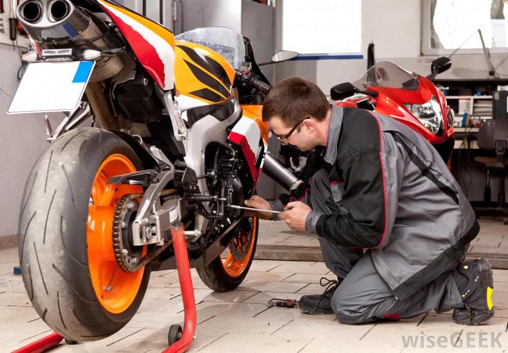 mechanic-fixing-motorcycle-engine